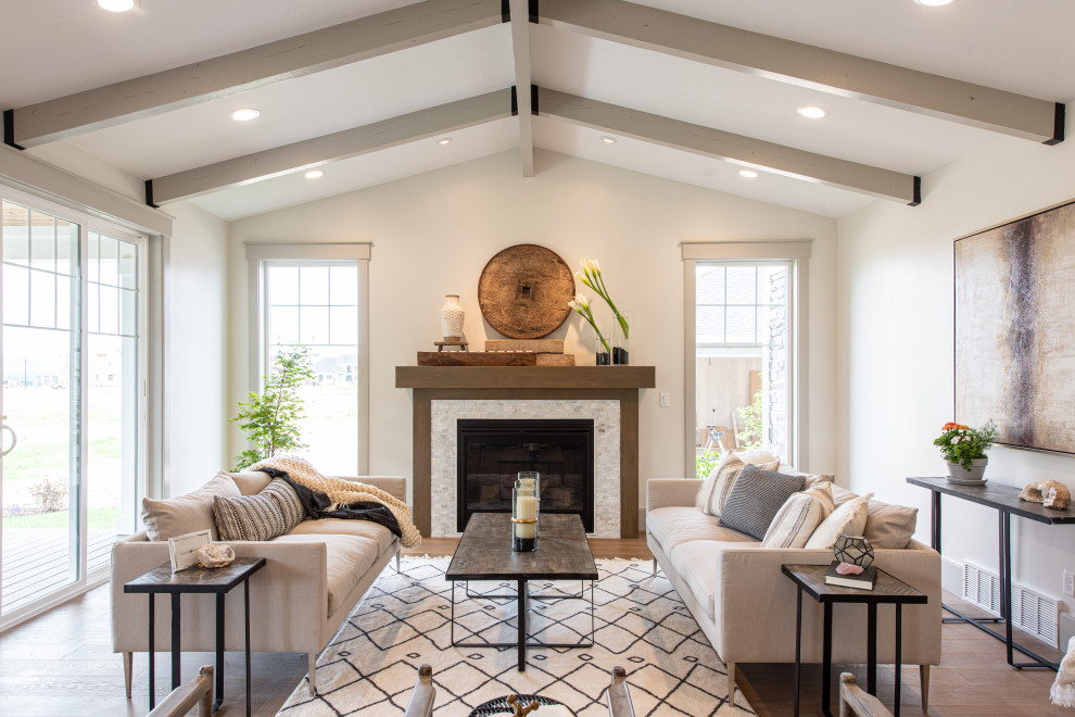 Photo of a large transitional formal enclosed living room in Salt Lake City with white walls, a standard fireplace, a tile fireplace surround, brown floor, medium hardwood floors and no tv.