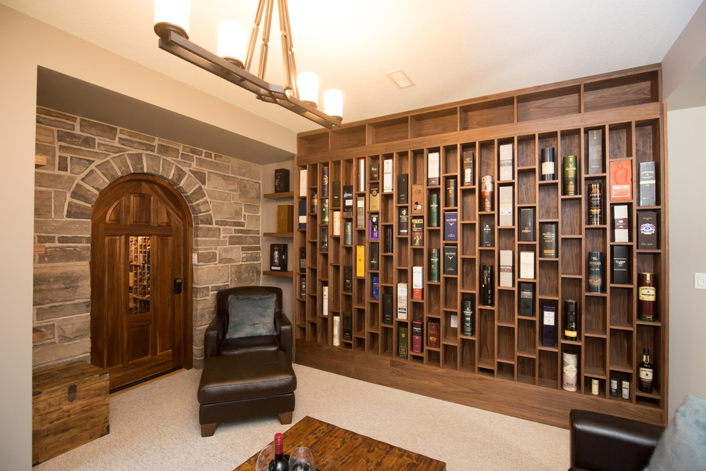 This is an example of a mediterranean single-wall home bar in Toronto with open cabinets, medium wood cabinets, carpet and grey floor.