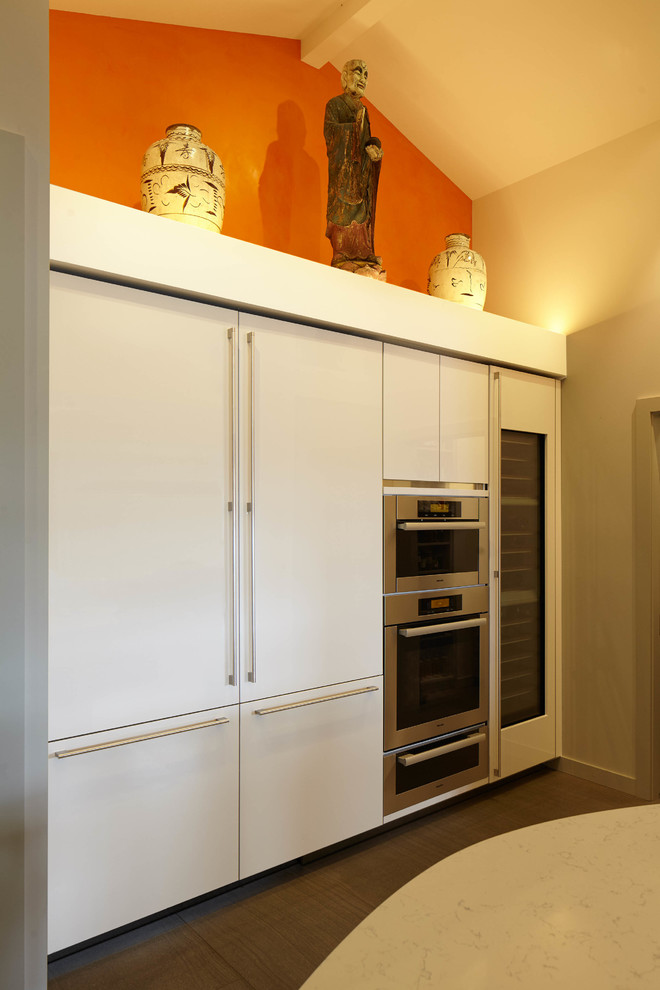 Inspiration for a large transitional gray floor and ceramic tile eat-in kitchen remodel in Seattle with quartzite countertops, stainless steel appliances, two islands, an undermount sink, flat-panel cabinets, dark wood cabinets and white countertops