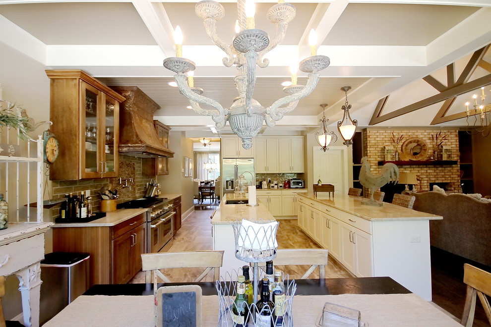 Example of a transitional medium tone wood floor open concept kitchen design with an undermount sink, flat-panel cabinets, light wood cabinets, granite countertops, beige backsplash, ceramic backsplash, stainless steel appliances and two islands