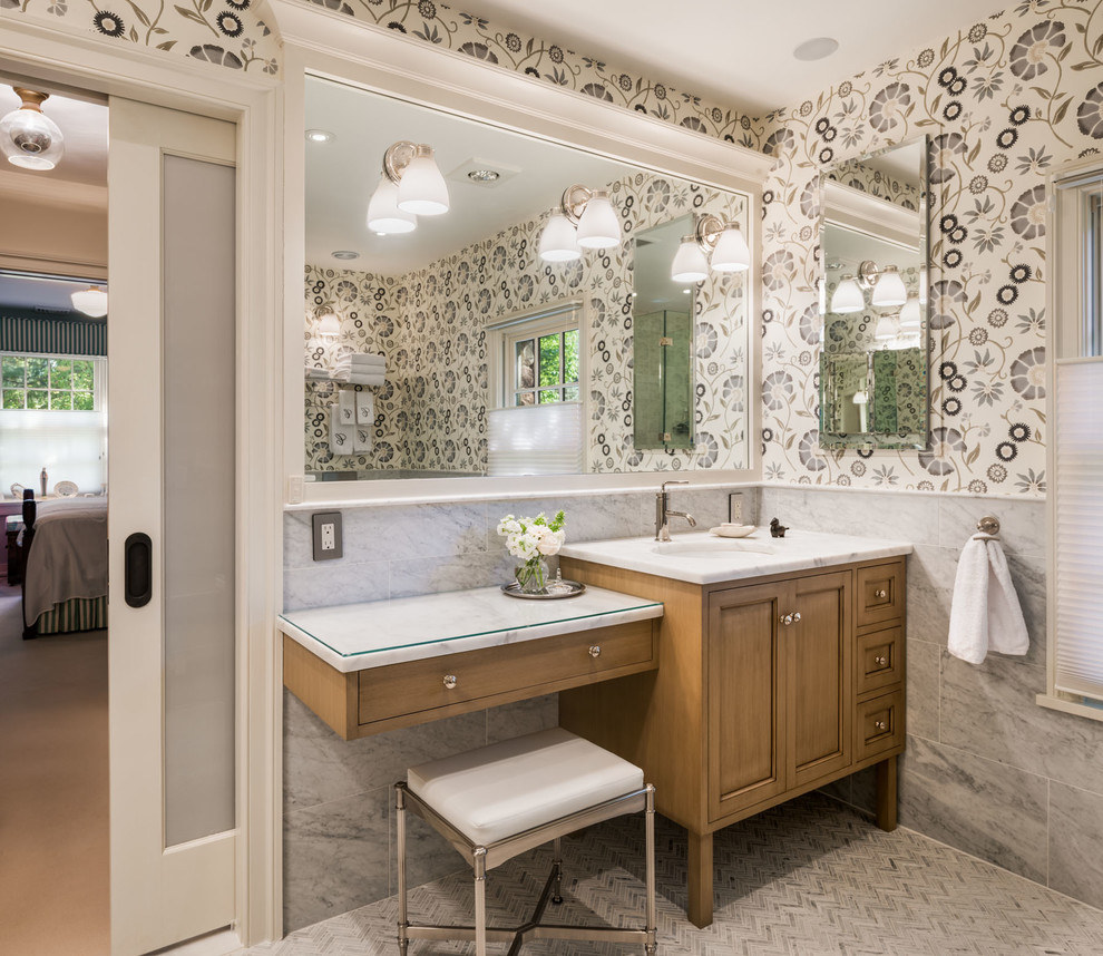 Inspiration for an expansive transitional 3/4 bathroom in Philadelphia with recessed-panel cabinets, medium wood cabinets, grey walls, an undermount sink, marble benchtops, white tile, stone slab, marble floors, a corner shower and a one-piece toilet.