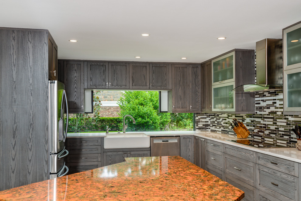 This is an example of a modern u-shaped eat-in kitchen in Tampa with a farmhouse sink, shaker cabinets, dark wood cabinets, quartz benchtops, multi-coloured splashback, glass tile splashback, stainless steel appliances, travertine floors and with island.