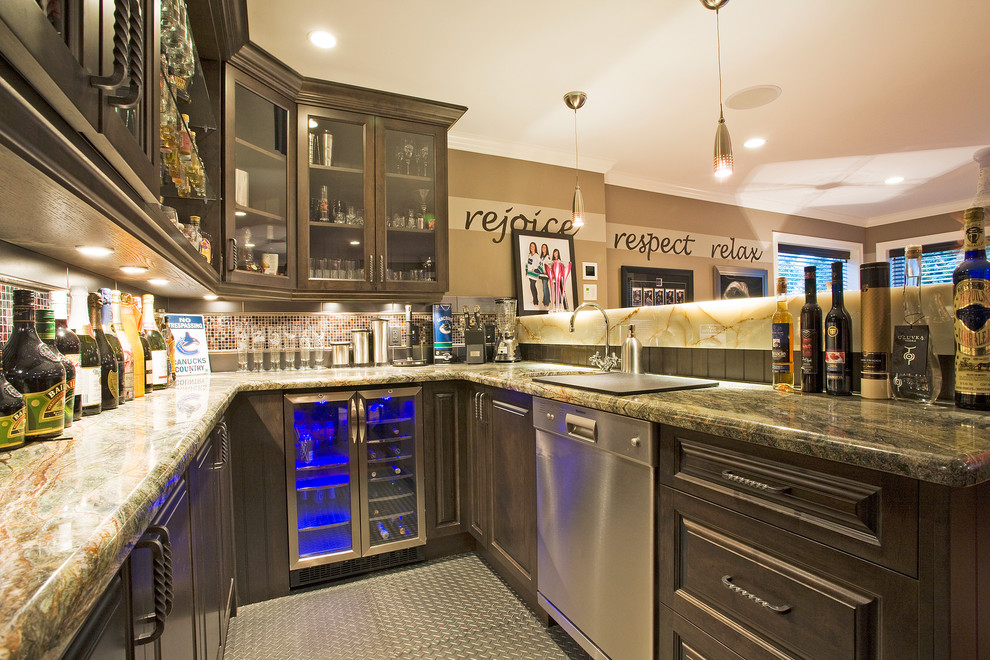 Photo of a large traditional u-shaped home bar in Vancouver with an undermount sink, raised-panel cabinets, medium wood cabinets, granite benchtops, brown splashback, mosaic tile splashback and linoleum floors.