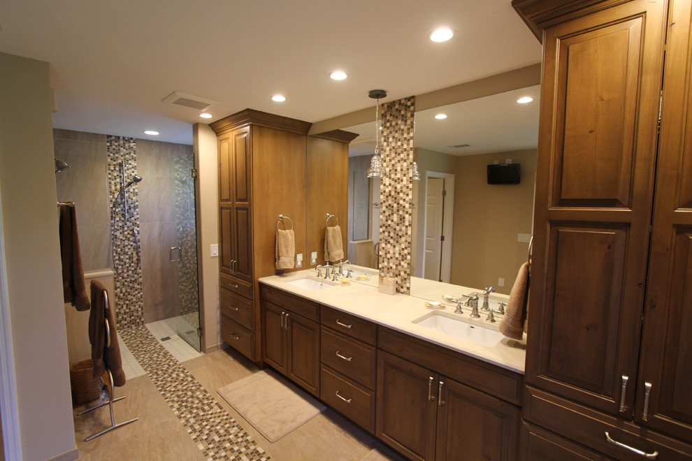 Example of a large trendy master alcove shower design in Orlando with raised-panel cabinets, medium tone wood cabinets, beige walls and an undermount sink