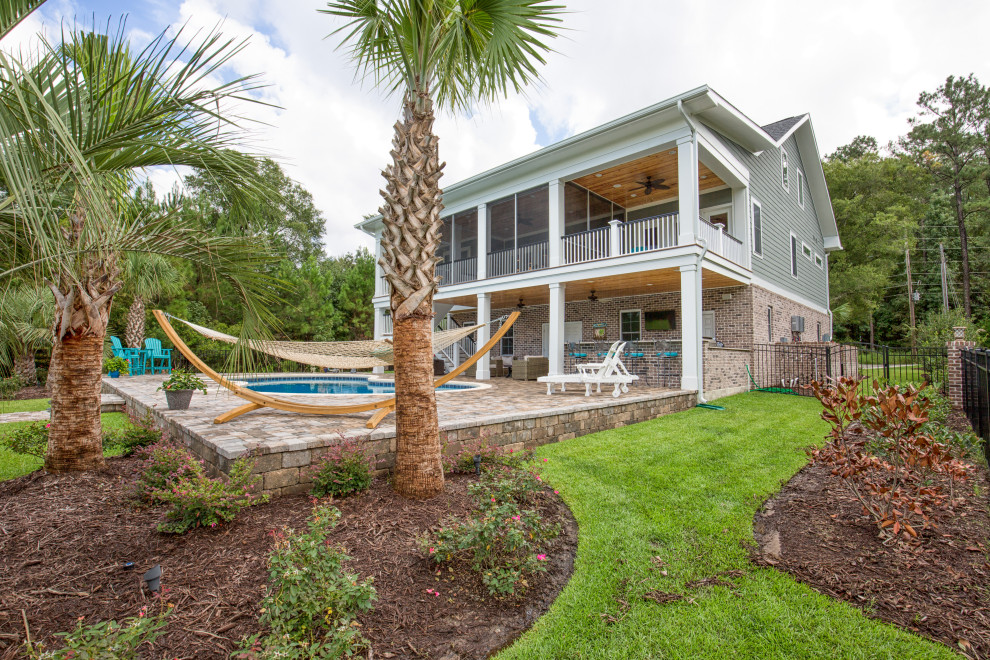 Pool - large transitional backyard concrete paver and custom-shaped pool idea