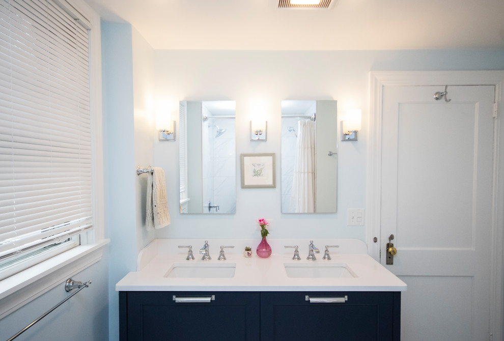 Inspiration for a mid-sized modern master bathroom in Providence with beaded inset cabinets, blue cabinets, a drop-in tub, an open shower, a one-piece toilet, white tile, ceramic tile, blue walls, ceramic floors, an undermount sink, tile benchtops, white floor and a shower curtain.