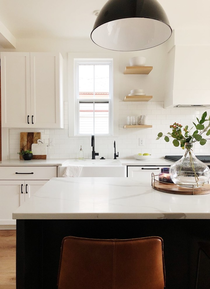 Inspiration for a mid-sized country galley kitchen in Indianapolis with shaker cabinets, white cabinets, quartz benchtops, white splashback, subway tile splashback, with island and white benchtop.