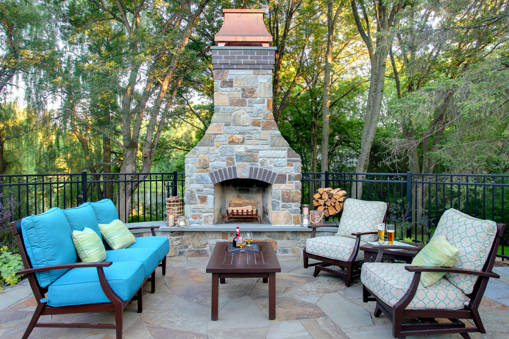 This is an example of a transitional backyard patio in Minneapolis with no cover and with fireplace.