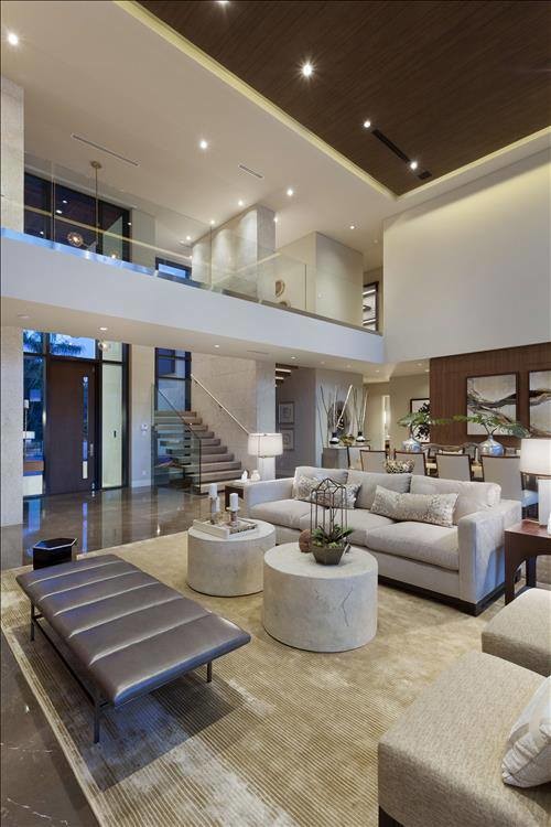 This is an example of a mid-sized contemporary formal open concept living room in New York with white walls, porcelain floors, a concrete fireplace surround and brown floor.