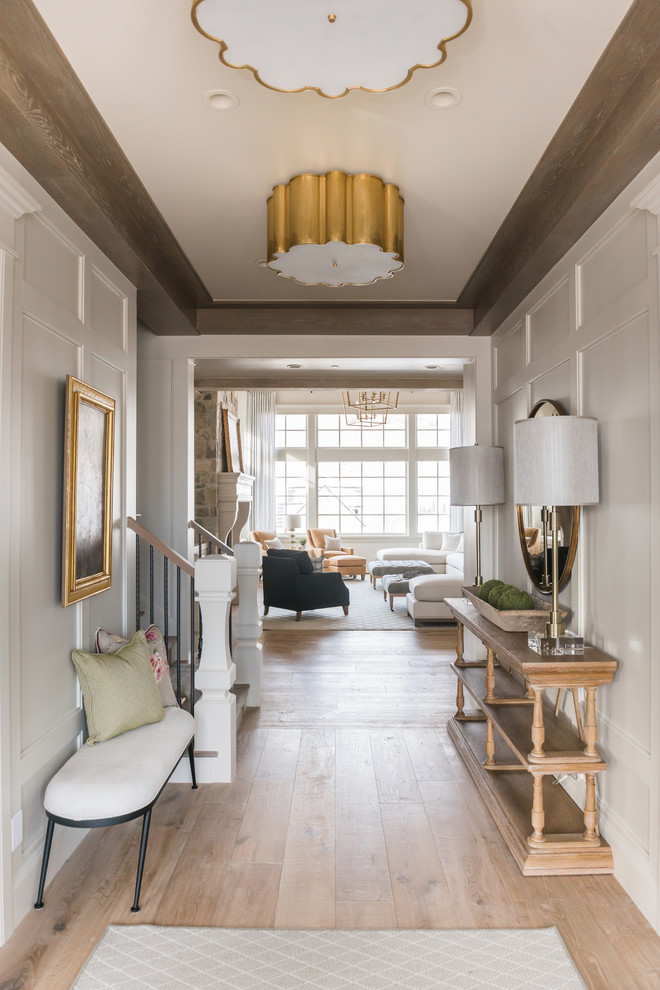 Example of a mid-sized classic light wood floor and beige floor hallway design in Salt Lake City with white walls