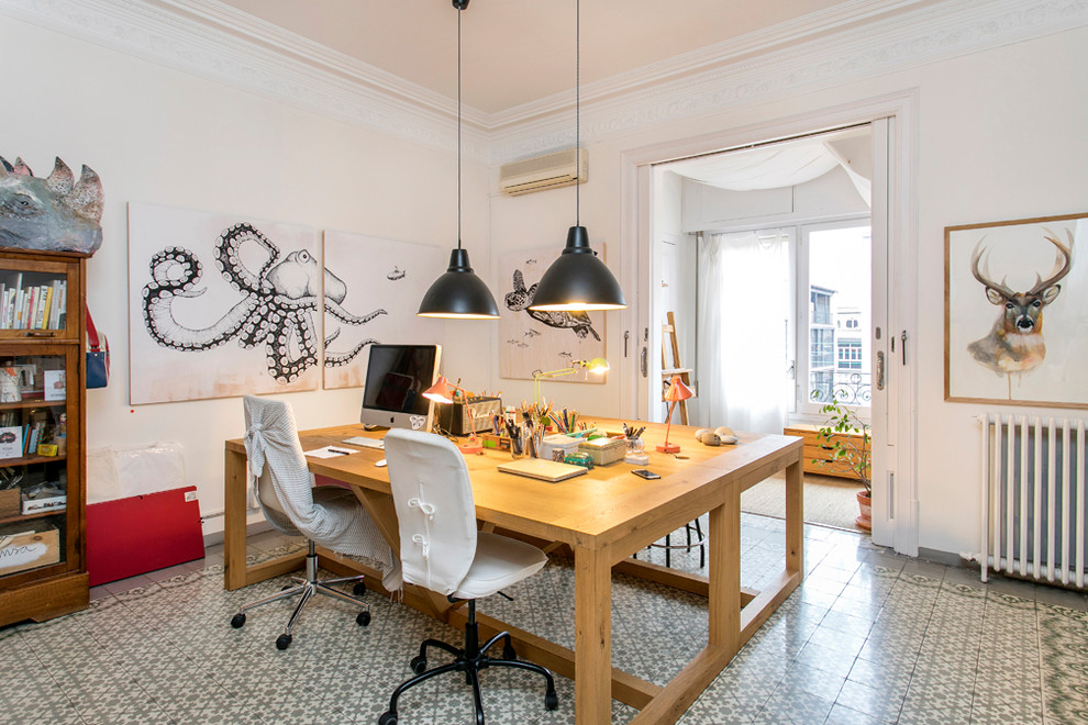 Photo of a mid-sized eclectic craft room in Barcelona with white walls, ceramic floors, no fireplace, a freestanding desk and multi-coloured floor.