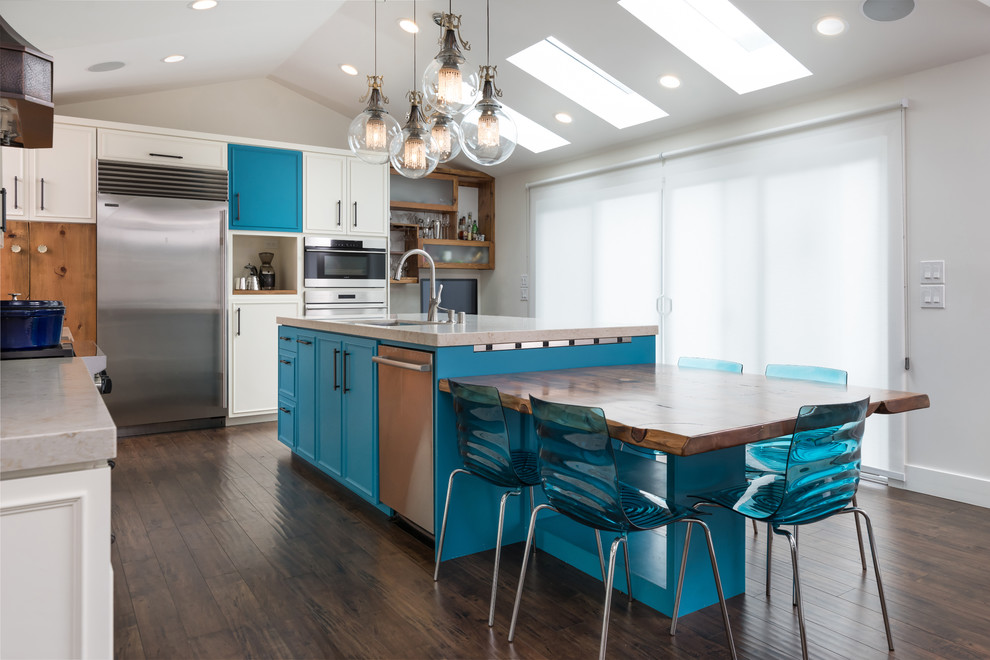 Inspiration for a large eclectic l-shaped open plan kitchen in San Francisco with an undermount sink, beaded inset cabinets, turquoise cabinets, quartz benchtops, blue splashback, mosaic tile splashback, stainless steel appliances, laminate floors, with island, multi-coloured floor and beige benchtop.