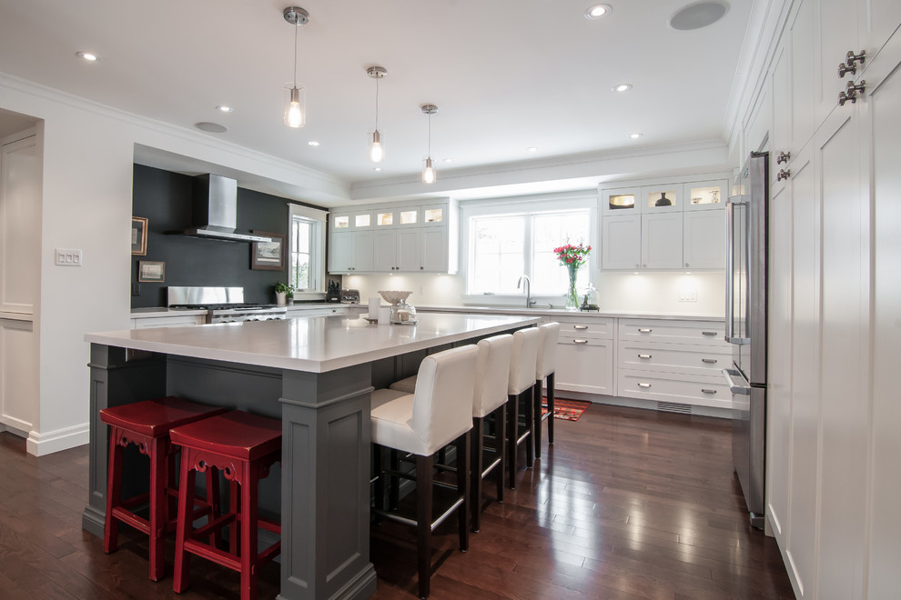 This is an example of a modern l-shaped separate kitchen in Toronto with an undermount sink, shaker cabinets, white cabinets, marble benchtops, white splashback, stainless steel appliances, dark hardwood floors and with island.