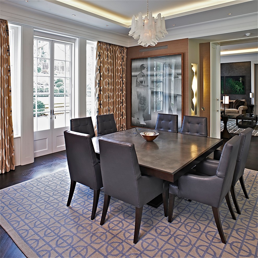 This is an example of a contemporary separate dining room in London with dark hardwood floors.