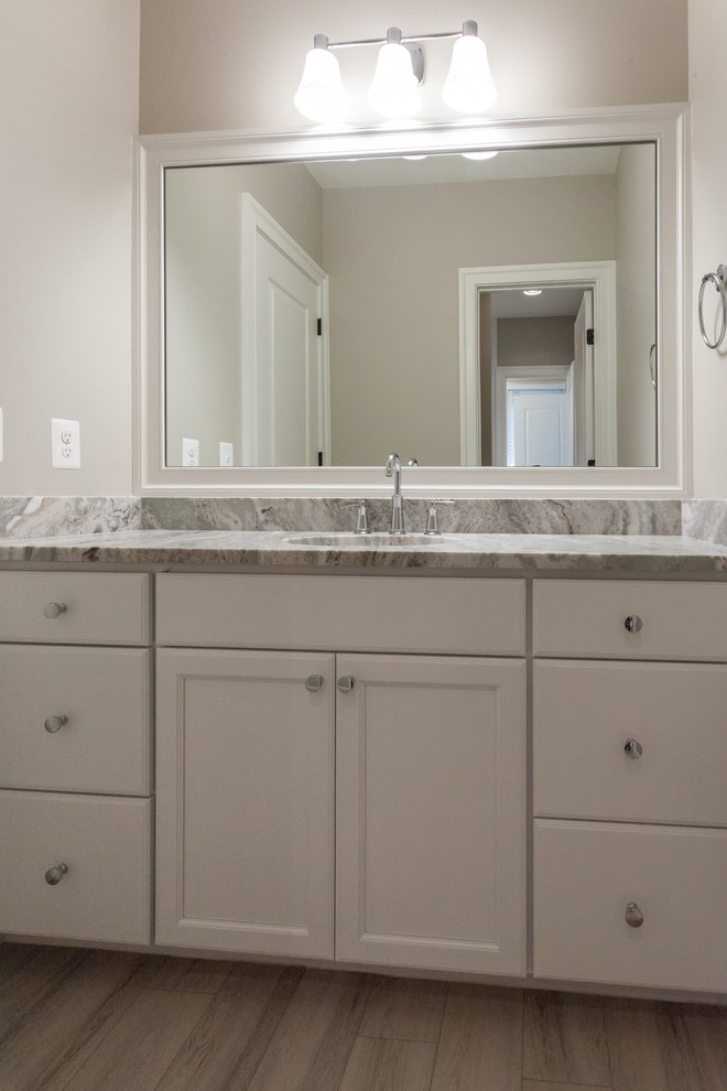 Inspiration for a transitional kids' white tile and subway tile beige floor home design remodel in DC Metro with recessed-panel cabinets, white cabinets, beige walls, an undermount sink and beige countertops