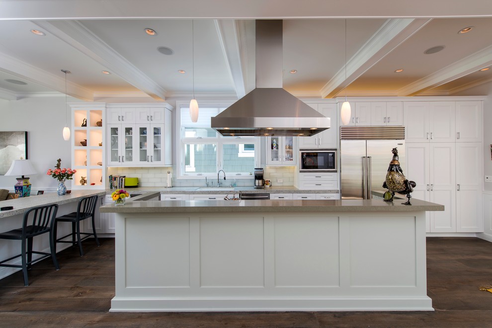 Traditional galley open plan kitchen in Los Angeles with shaker cabinets, white cabinets and stainless steel appliances.