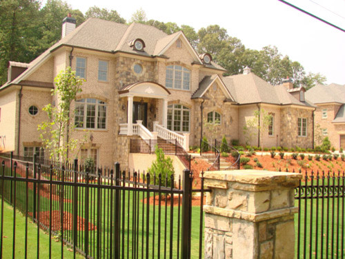 Design ideas for a large traditional three-storey beige exterior in Atlanta with stone veneer and a hip roof.