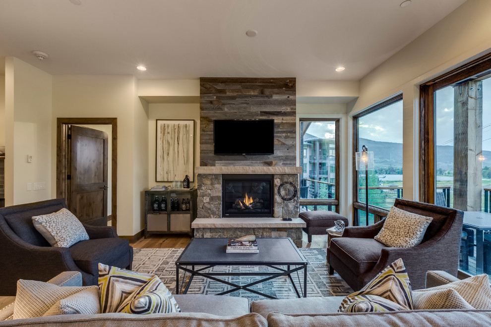 Contemporary open concept living room in Denver with a standard fireplace and a stone fireplace surround.