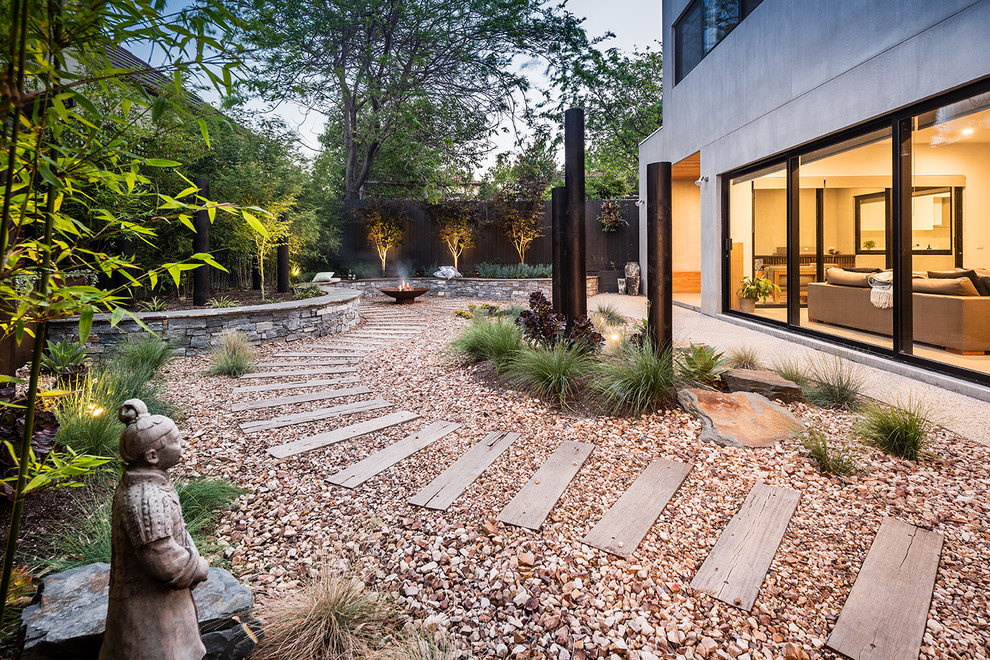 Design ideas for a large asian backyard partial sun garden in Melbourne with a fire feature and gravel.