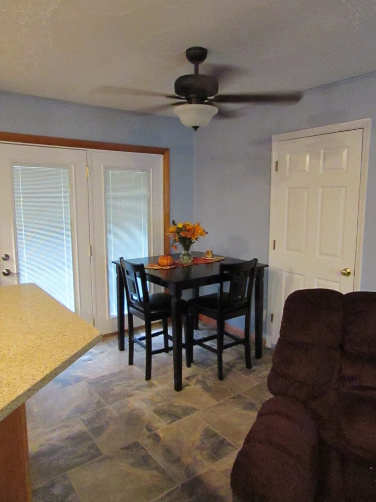 Home design - mid-sized transitional l-shaped ceramic tile home design idea with a double-bowl sink, raised-panel cabinets, light wood cabinets, quartz countertops, multicolored backsplash, mosaic tile backsplash, stainless steel appliances and an island