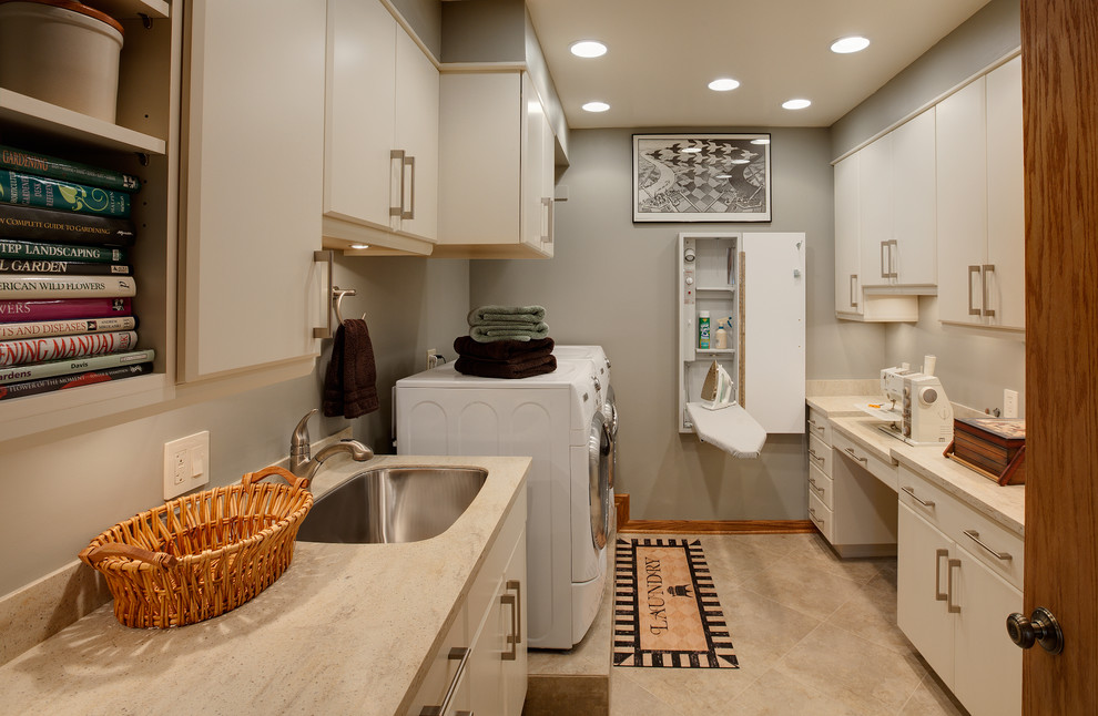 Inspiration for a contemporary laundry room in Chicago with grey walls and white cabinets.