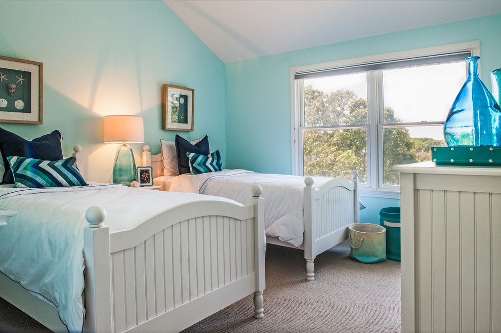 This is an example of a mid-sized beach style guest bedroom in Boston with blue walls, carpet, no fireplace and beige floor.