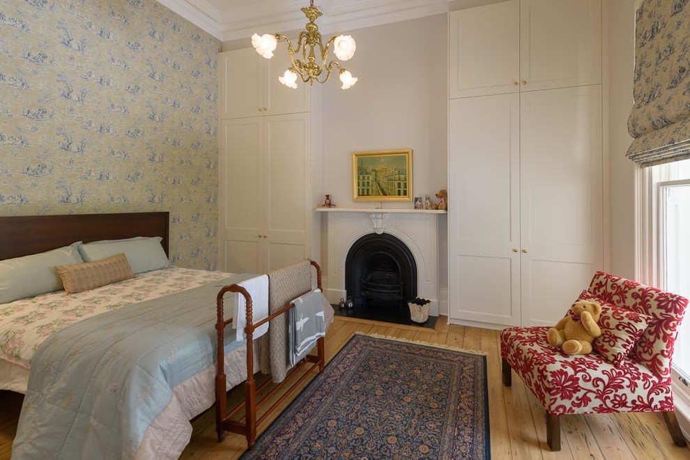 This is an example of a mid-sized traditional bedroom in Melbourne with light hardwood floors.