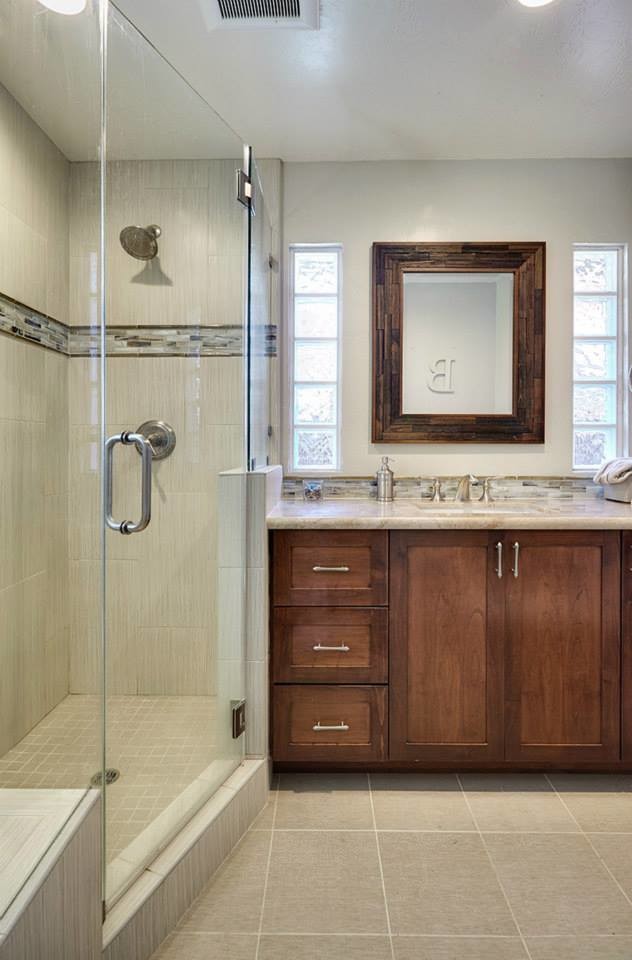 Photo of a mid-sized modern bathroom in Sacramento with a drop-in sink, flat-panel cabinets, dark wood cabinets, granite benchtops, a corner shower, beige tile, stone tile, beige walls and ceramic floors.