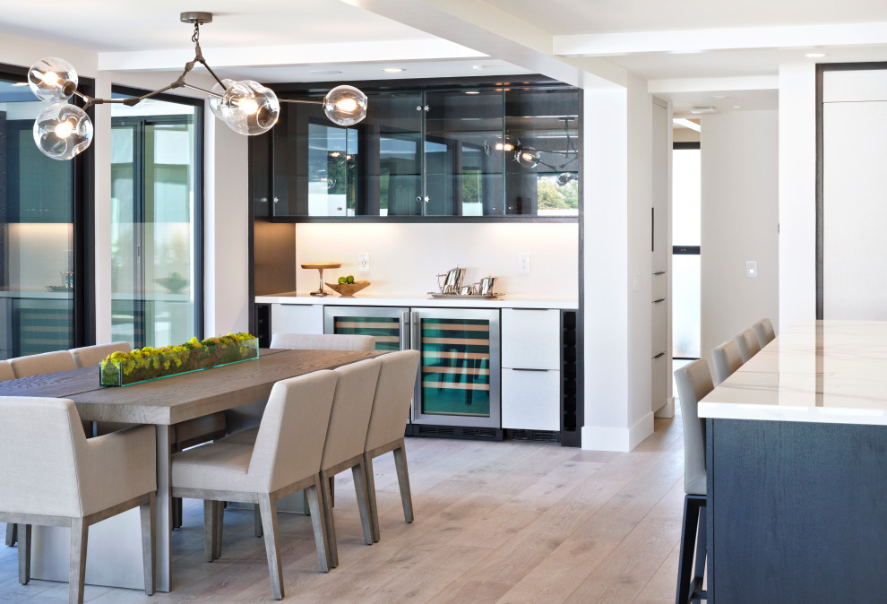 Kitchen/dining room combo - large contemporary light wood floor and gray floor kitchen/dining room combo idea in Orange County with white walls and no fireplace