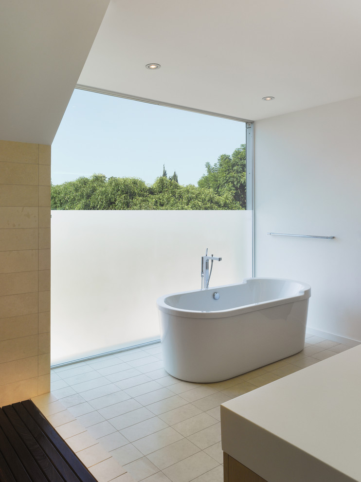 Photo of a small modern master bathroom in Los Angeles with a freestanding tub, beige tile, porcelain tile, white walls, porcelain floors and engineered quartz benchtops.