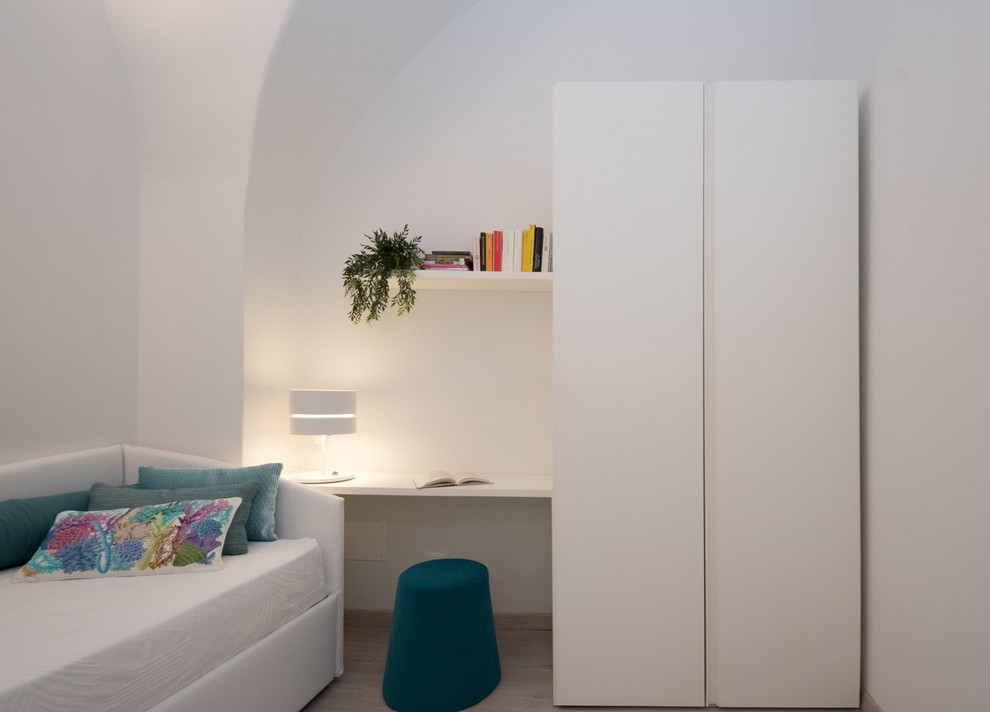 Photo of a mediterranean guest bedroom in Other with white walls and laminate floors.