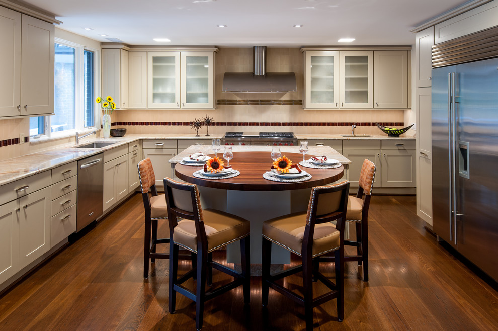 Photo of a large contemporary l-shaped eat-in kitchen in DC Metro with an undermount sink, shaker cabinets, stainless steel cabinets, granite benchtops, pink splashback, ceramic splashback, stainless steel appliances, dark hardwood floors and multiple islands.