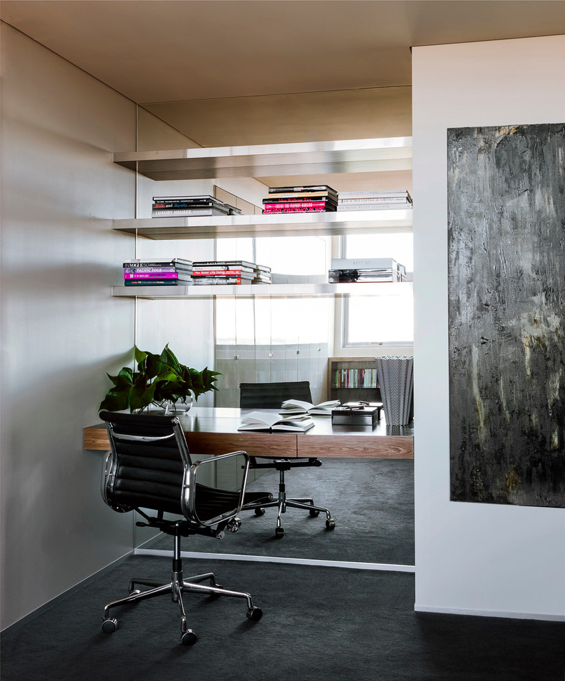 Inspiration for a small contemporary study room in Sydney with carpet, a built-in desk and black floor.