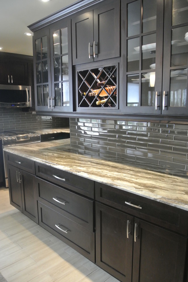 Mid-sized transitional u-shaped eat-in kitchen photo in Toronto with an undermount sink, shaker cabinets, dark wood cabinets, quartzite countertops, stainless steel appliances and an island