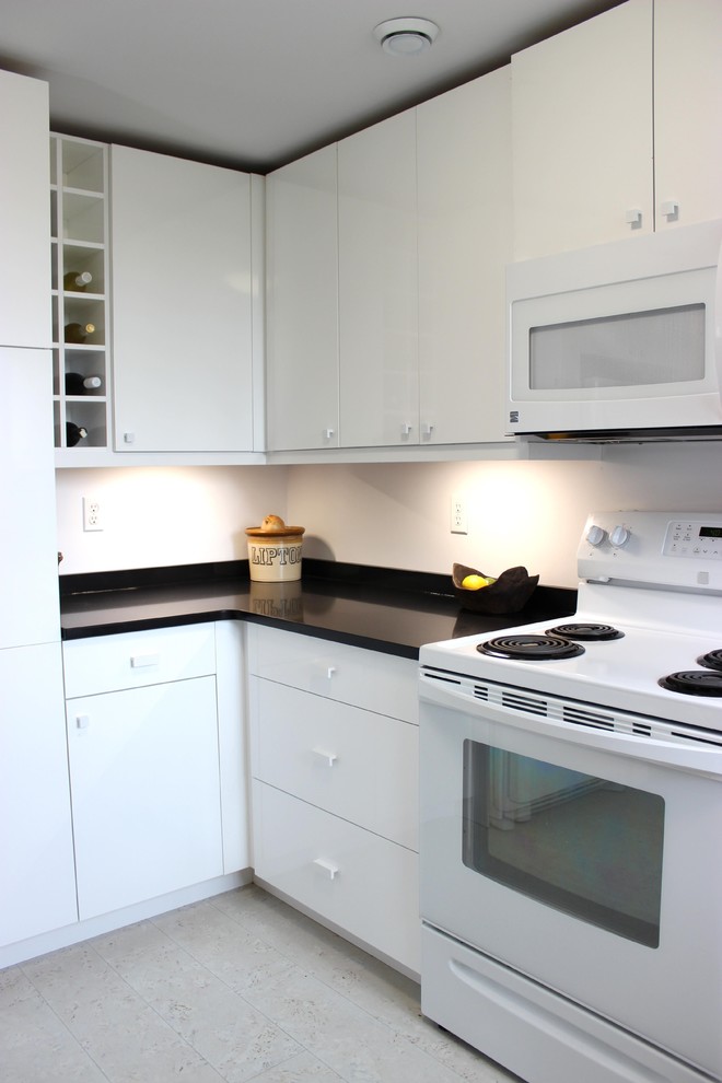 This is an example of a mid-sized modern l-shaped separate kitchen in Other with flat-panel cabinets, white cabinets, solid surface benchtops, white appliances, porcelain floors and grey floor.