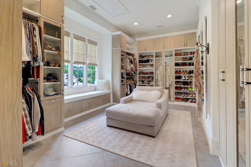 Design ideas for a large gender-neutral walk-in wardrobe in Atlanta with shaker cabinets, light wood cabinets and grey floor.