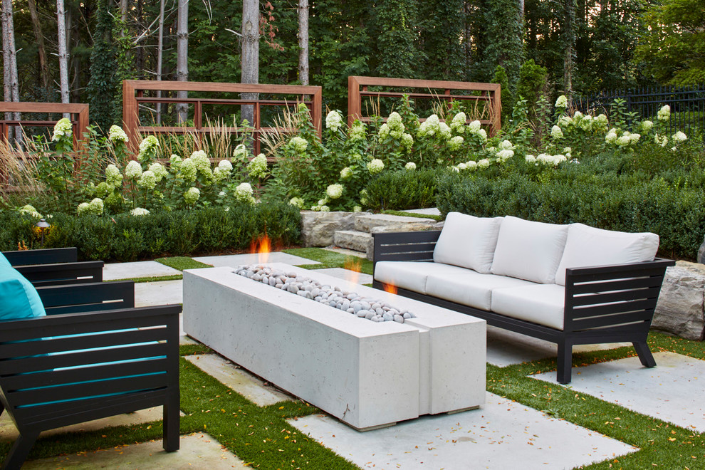 Inspiration for an expansive traditional backyard partial sun formal garden for summer in Toronto with natural stone pavers and a fire feature.
