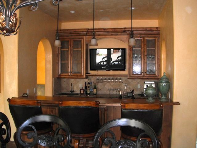 This is an example of a mediterranean home bar in Other.
