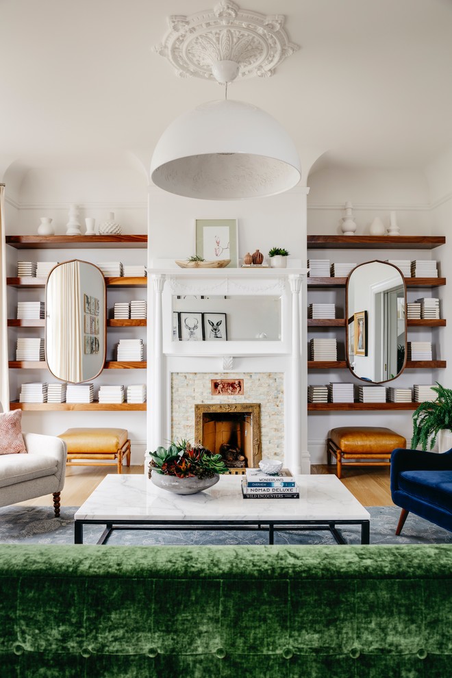 This is an example of a transitional living room in San Francisco with white walls, medium hardwood floors, a standard fireplace, a tile fireplace surround and brown floor.