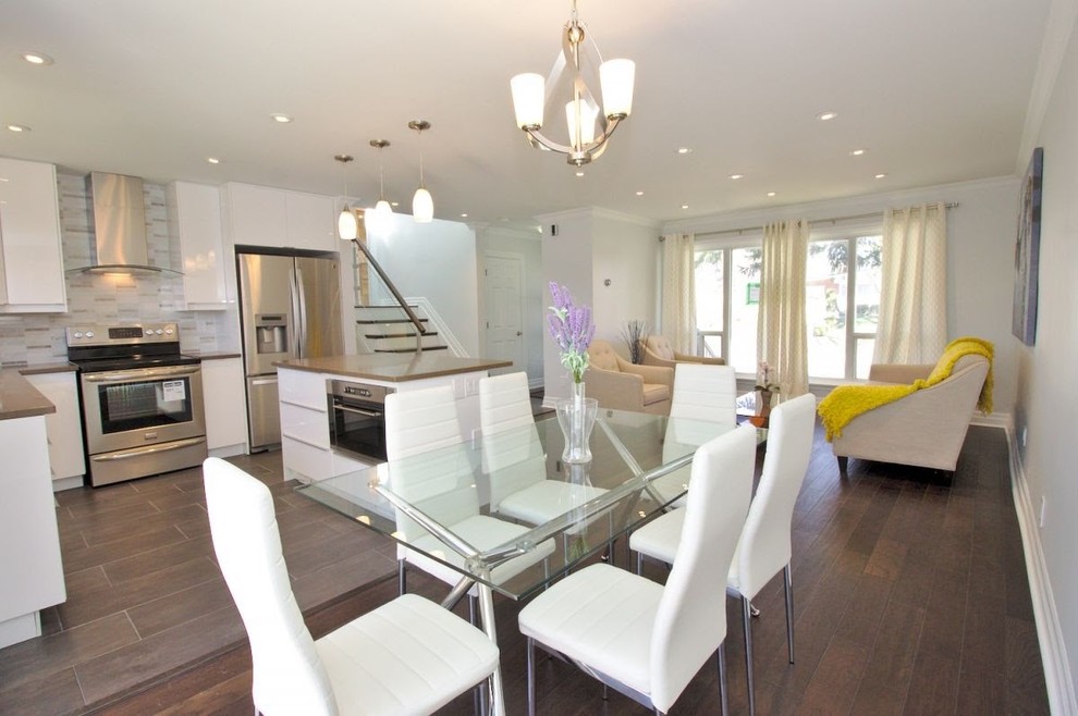 Mid-sized transitional open plan dining in Toronto with white walls, dark hardwood floors, brown floor and no fireplace.