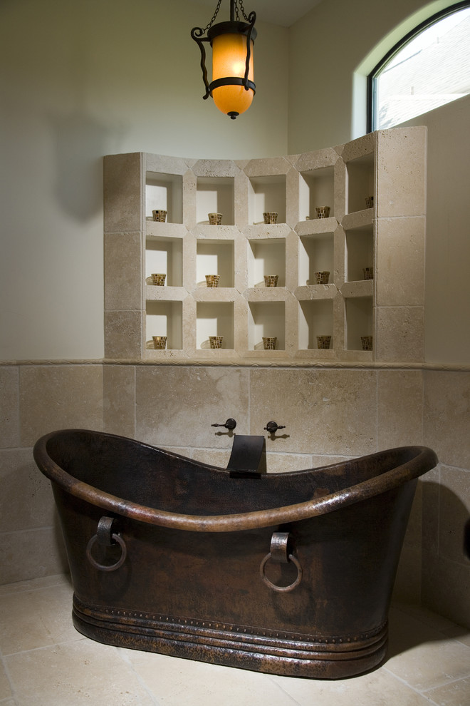 Photo of a mediterranean bathroom in Houston with a freestanding tub.
