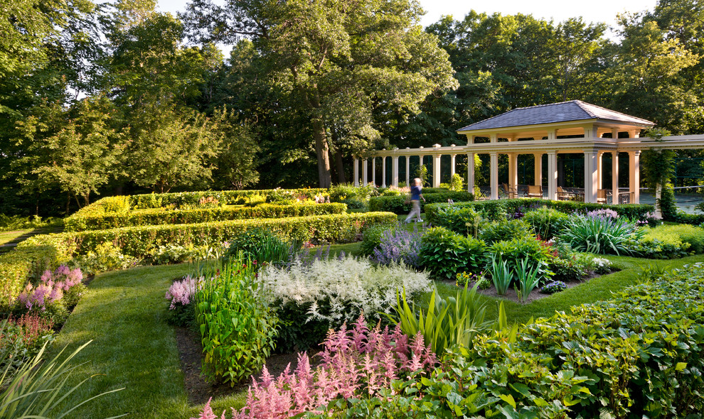 This is an example of a large traditional formal garden in Minneapolis with with flowerbed.