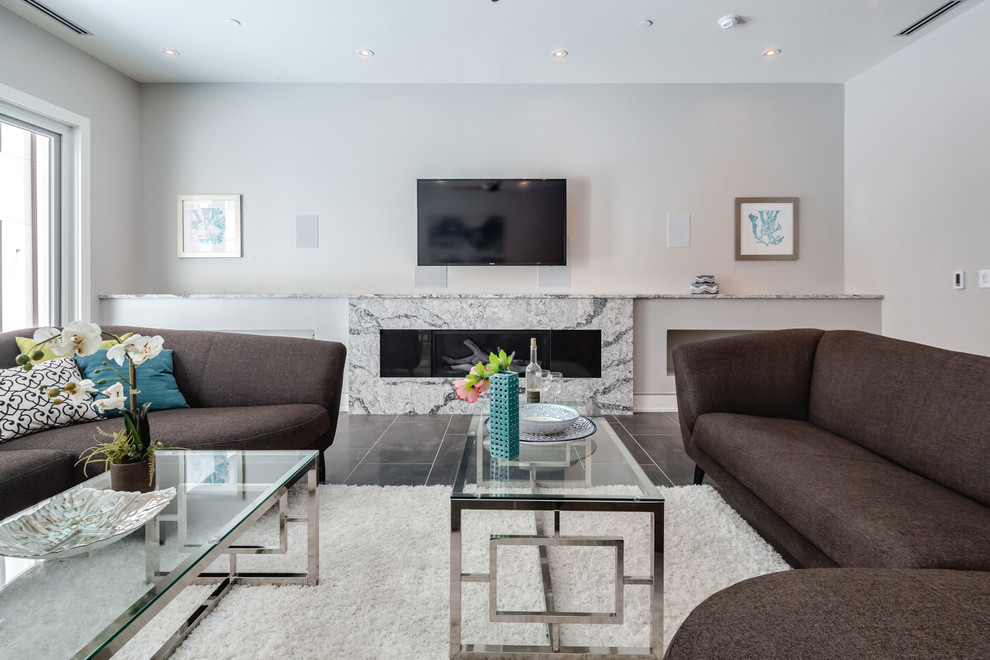 This is an example of a large contemporary open concept family room in Philadelphia with grey walls, porcelain floors, a ribbon fireplace, a stone fireplace surround, a wall-mounted tv and black floor.
