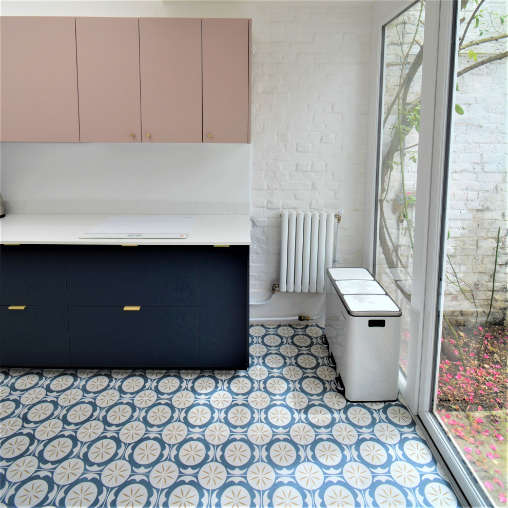 Inspiration for a large traditional galley separate kitchen in Lille with an undermount sink, flat-panel cabinets, blue cabinets, quartzite benchtops, white splashback, engineered quartz splashback, panelled appliances, cement tiles, no island, blue floor and white benchtop.