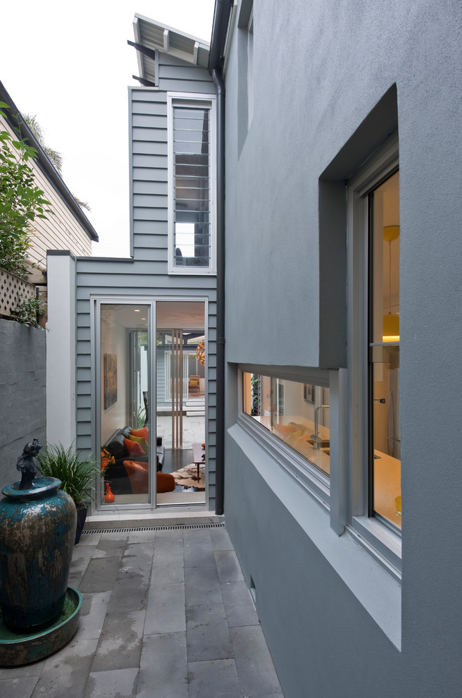 Inspiration for a small contemporary two-storey grey townhouse exterior in Sydney with a metal roof.