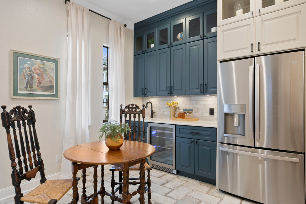 Inspiration for a mid-sized contemporary l-shaped home bar in Tampa with an undermount sink, shaker cabinets, blue cabinets, quartz benchtops, white splashback, stone tile splashback and beige floor.
