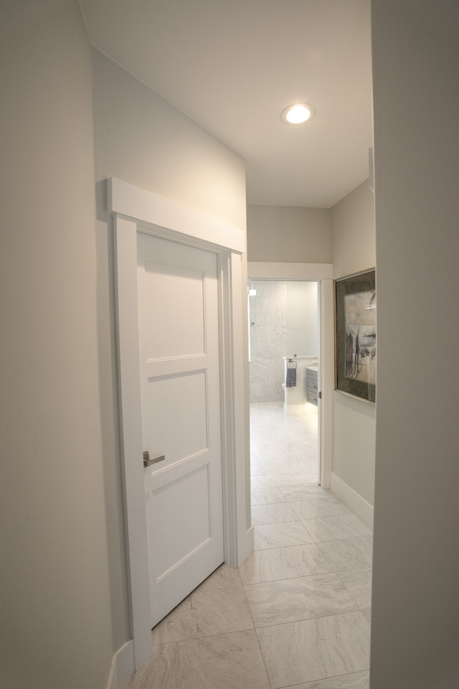Inspiration for a small contemporary hallway in Other with beige walls, porcelain floors and white floor.