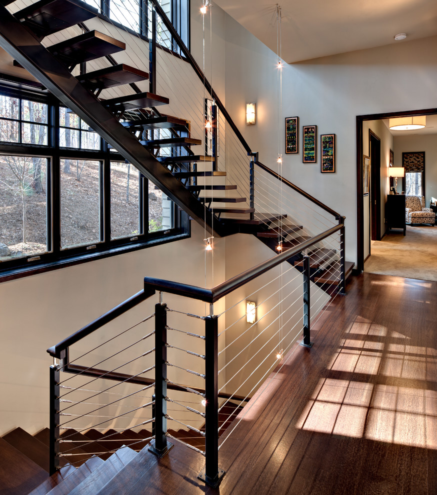 Design ideas for a large wood floating staircase in Other with open risers and wood railing.