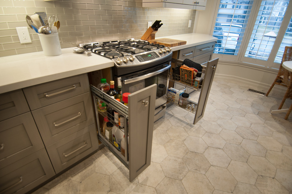 Mid-sized transitional galley ceramic tile enclosed kitchen photo in Toronto with shaker cabinets, white cabinets, quartzite countertops, gray backsplash, glass tile backsplash, stainless steel appliances and no island