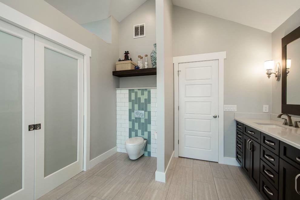 Photo of a mid-sized contemporary master bathroom in Los Angeles with shaker cabinets, dark wood cabinets, a curbless shower, a one-piece toilet, multi-coloured tile, porcelain tile, beige walls, plywood floors, an integrated sink, solid surface benchtops, beige floor, a sliding shower screen and white benchtops.